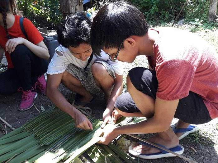 Learning how to weave nipa roofing