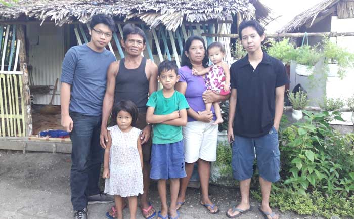 Research team Kyle (extreme left) and Paolo (right) with their host family from PODIS